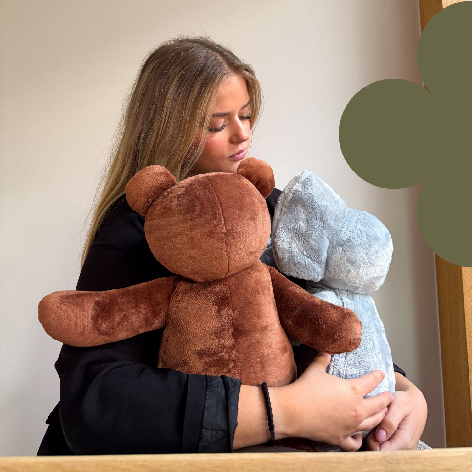 Vrouw die twee Hugsback verzwaringsknuffels vasthoudt voor diepe druk, ontspanning en stressverlichting. Ideaal voor kinderen en volwassenen die meer rust en geborgenheid zoeken.